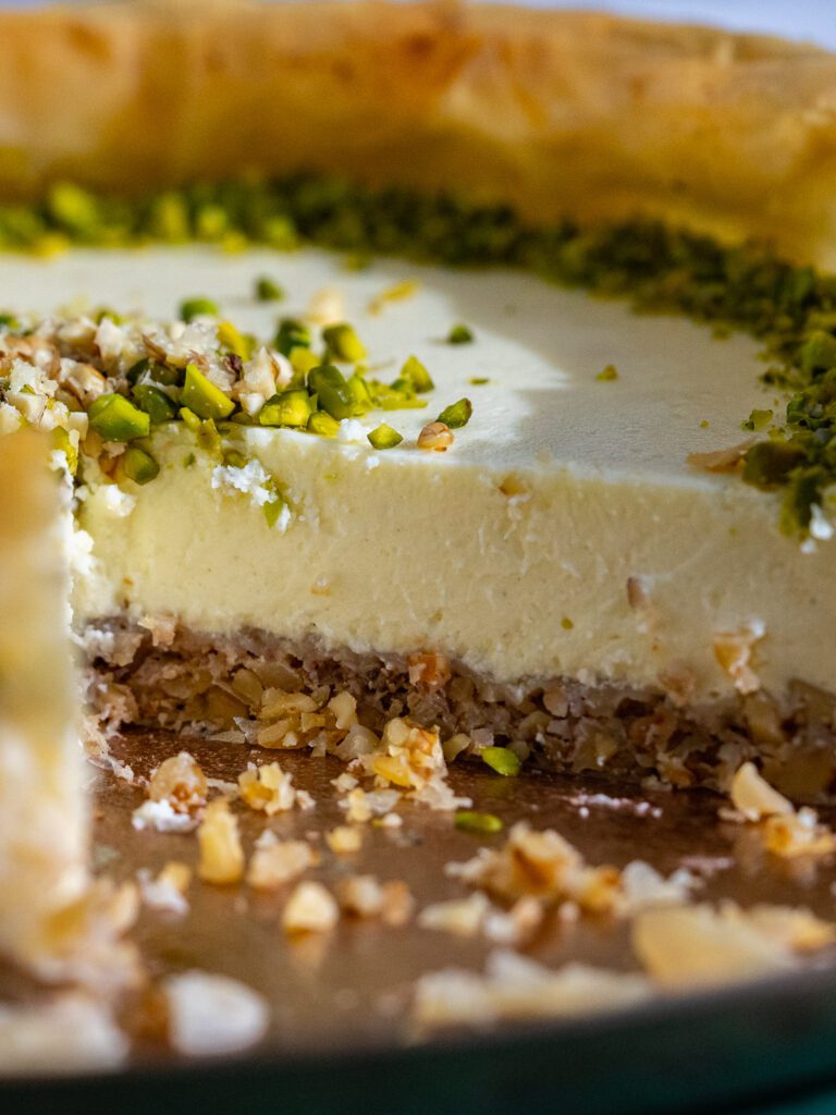 Baklava cheesecake sliced on a plate.