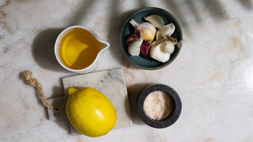 Ingredients for toum are laid out on a work surface.