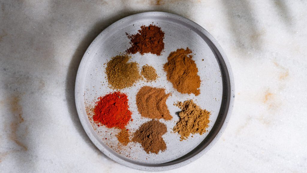 Ground spices for baharat are already on a plate.