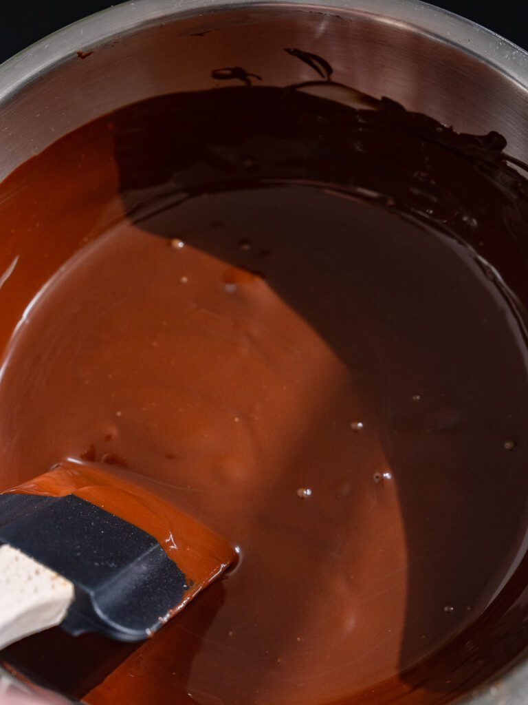 Melted chocolate is stirred.